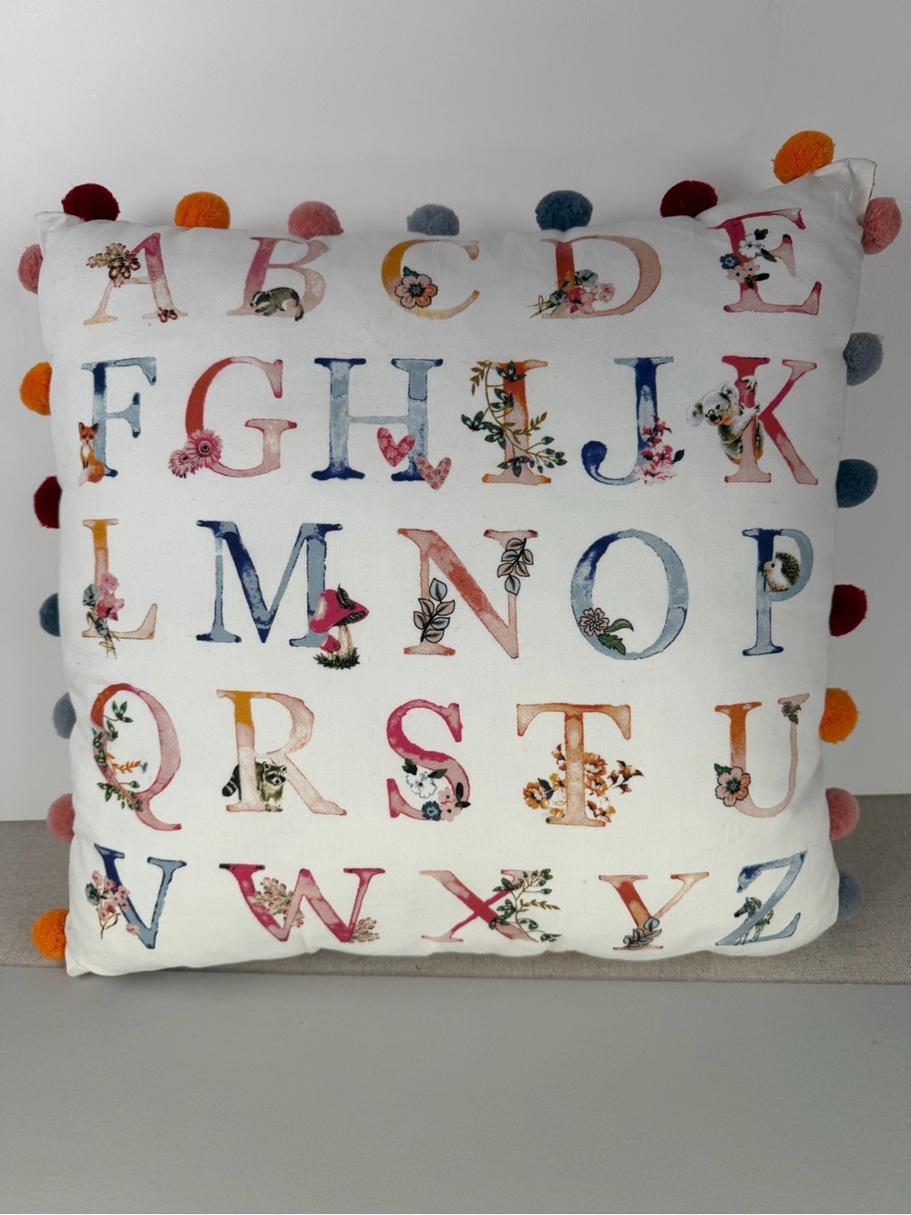 Matilda Jane Alphabet Decorative Pillow with Multicolor Pom Pom Trim